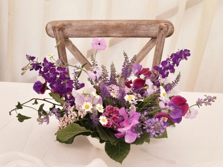 Wedding table centerpiece in lilacs and purples